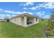 Spacious backyard with covered patio and lush green lawn at 3418 Wynwood Forest Dr, Ocoee, FL 34761
