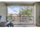Screened balcony overlooking parking area and nearby residential buildings under a partly cloudy sky at 3428 Soho # 301, Orlando, FL 32811