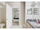 Bright bathroom showcasing a doorway leading to the bedroom and vanity with a sink at 3428 Soho # 301, Orlando, FL 32811