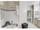 Bathroom showcasing a tub with a shower, gray tile, and a doorway leading to the bedroom at 3428 Soho # 301, Orlando, FL 32811
