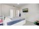 Bright bedroom featuring a comfortable bed and a mounted TV at 3428 Soho # 301, Orlando, FL 32811