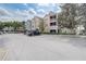 Exterior view of a condominium complex with ample parking at 3428 Soho # 301, Orlando, FL 32811