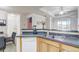 Bright kitchen featuring stainless steel sink, modern appliances, and a view to the living area at 3428 Soho # 301, Orlando, FL 32811