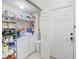 Functional laundry room with a washer, dryer, shelving and ample storage at 3428 Soho # 301, Orlando, FL 32811