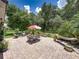 Expansive backyard features a large brick patio, outdoor seating, lush greenery, and shade trees at 3556 Sunset Isles Blvd., Kissimmee, FL 34746