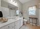 Clean bathroom with marble vanity, double sinks, decorative mirror, and ample counter space at 3556 Sunset Isles Blvd., Kissimmee, FL 34746