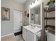 This bathroom boasts a bright vanity, mirror, and stylish fixtures, all set against neutral tile flooring at 3556 Sunset Isles Blvd., Kissimmee, FL 34746