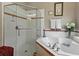 Bathroom featuring a glass-enclosed shower, tub with tile surround, and decorative accents at 3556 Sunset Isles Blvd., Kissimmee, FL 34746