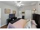 Comfortable bedroom features a plush bed, dark wood furniture, and a ceiling fan at 3556 Sunset Isles Blvd., Kissimmee, FL 34746