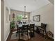 Elegant dining room with wood floors, modern chandelier, and natural light at 3556 Sunset Isles Blvd., Kissimmee, FL 34746