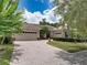 Charming single-story home with a brick driveway and lush landscaping at 3556 Sunset Isles Blvd., Kissimmee, FL 34746