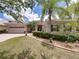 Charming single-story home featuring a well-manicured lawn, mature trees, and a two-car garage at 3556 Sunset Isles Blvd., Kissimmee, FL 34746