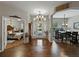 Inviting foyer with wood floors, chandelier, and views into the dining room and bedroom at 3556 Sunset Isles Blvd., Kissimmee, FL 34746