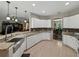 Bright, open kitchen featuring white cabinets, granite countertops, and stainless steel appliances at 3556 Sunset Isles Blvd., Kissimmee, FL 34746
