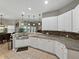 Spacious kitchen boasts white cabinetry, granite counters, and seamless flow to the dining area at 3556 Sunset Isles Blvd., Kissimmee, FL 34746