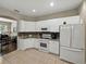 Well-equipped kitchen with modern white appliances, granite countertops, and ample cabinet space at 3556 Sunset Isles Blvd., Kissimmee, FL 34746