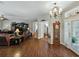 Spacious living room with wood floors, a fireplace, and a large window at 3556 Sunset Isles Blvd., Kissimmee, FL 34746