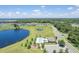 Aerial view of community pool, playground, and large lake offering serene outdoor living at 3759 Crimson Clover Dr, Mount Dora, FL 32757