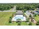 Aerial view of community pool with a playground and nearby amenities perfect for outdoor recreation and relaxation at 3759 Crimson Clover Dr, Mount Dora, FL 32757