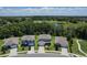Aerial view of well maintained homes and a beautiful green landscape with a small pond at 3759 Crimson Clover Dr, Mount Dora, FL 32757