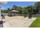 Spacious backyard with a screened-in gazebo, patio furniture, and well-maintained lawn at 3759 Crimson Clover Dr, Mount Dora, FL 32757