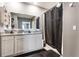 Bathroom with double vanity, granite countertops, and sleek gray cabinets at 3759 Crimson Clover Dr, Mount Dora, FL 32757