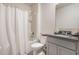 Clean bathroom features a shower with a white curtain, granite countertops, and ample storage space at 3759 Crimson Clover Dr, Mount Dora, FL 32757