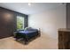 Simple bedroom with neutral carpet, gray and white painted walls, and a framed bed pushed against the wall at 3759 Crimson Clover Dr, Mount Dora, FL 32757