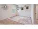 Bright bedroom featuring neutral carpet, white walls with decorative mirrors, and abundant natural light, creating a serene atmosphere at 3759 Crimson Clover Dr, Mount Dora, FL 32757