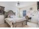 Bright bedroom with a large bed, plush bedding, a neutral color scheme, and a dedicated desk and workspace at 3759 Crimson Clover Dr, Mount Dora, FL 32757
