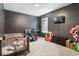 bedroom featuring dark walls, a TV, and play structures creating an engaging and fun space at 3759 Crimson Clover Dr, Mount Dora, FL 32757