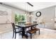 Bright dining room featuring a decorative light fixture, large window, and gray walls at 3759 Crimson Clover Dr, Mount Dora, FL 32757