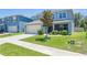 Charming two-story home with manicured lawn, a two-car garage, and beautiful landscaping at 3759 Crimson Clover Dr, Mount Dora, FL 32757