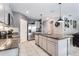 Modern kitchen features granite countertops, a stainless steel refrigerator, and stylish gray cabinets at 3759 Crimson Clover Dr, Mount Dora, FL 32757