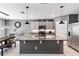 Modern kitchen with gray cabinets, stainless steel appliances, an island, and granite countertops at 3759 Crimson Clover Dr, Mount Dora, FL 32757