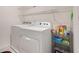 Efficient laundry area with a modern washer and dryer set, complemented by shelving for organized storage at 3759 Crimson Clover Dr, Mount Dora, FL 32757