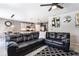 Open-concept living room with a view of the kitchen, modern decor, and a comfortable leather couch at 3759 Crimson Clover Dr, Mount Dora, FL 32757