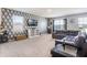 Modern living room features stylish wallpaper, plush carpeting, and a comfortable leather sofa, ideal for relaxation and entertainment at 3759 Crimson Clover Dr, Mount Dora, FL 32757