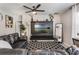 Comfortable living room with a large TV, ceiling fan, and a black-and-white patterned rug at 3759 Crimson Clover Dr, Mount Dora, FL 32757