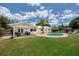 Private backyard featuring a sparkling pool, patio seating, and lush green lawn perfect for entertaining at 402 Saint Dunstan Way, Winter Park, FL 32792