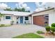 Charming home featuring a modern garage door, stylish front door, and landscaped front yard at 402 Saint Dunstan Way, Winter Park, FL 32792
