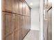 Hallway with ample storage cabinetry and light tile floors creating a clean and organized space at 402 Saint Dunstan Way, Winter Park, FL 32792
