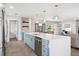 Bright, open kitchen with modern island, stainless steel appliances, and a seamless flow to living areas at 402 Saint Dunstan Way, Winter Park, FL 32792