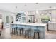 Bright kitchen island with seating, stainless steel appliances, and stylish pendant lighting above at 402 Saint Dunstan Way, Winter Park, FL 32792
