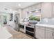 Well-equipped kitchen featuring stainless steel appliances, quartz countertops, and ample cabinet space at 402 Saint Dunstan Way, Winter Park, FL 32792