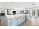 Open kitchen with a large island, stainless steel appliances, and seamless flow to the living spaces at 402 Saint Dunstan Way, Winter Park, FL 32792