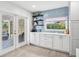 Bright kitchen nook with blue tiled backsplash, open shelving, and lots of counter space at 402 Saint Dunstan Way, Winter Park, FL 32792