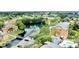Aerial view of a community with a lake, pool, apartments, and golf carts at 4606 Commander Dr # 1126, Orlando, FL 32822