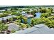 Aerial view of a community with a pool, tennis court, a lake, and plenty of trees at 4606 Commander Dr # 1126, Orlando, FL 32822