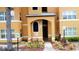 Inviting entrance to the building with well-maintained landscaping and clear signage at 4606 Commander Dr # 1126, Orlando, FL 32822